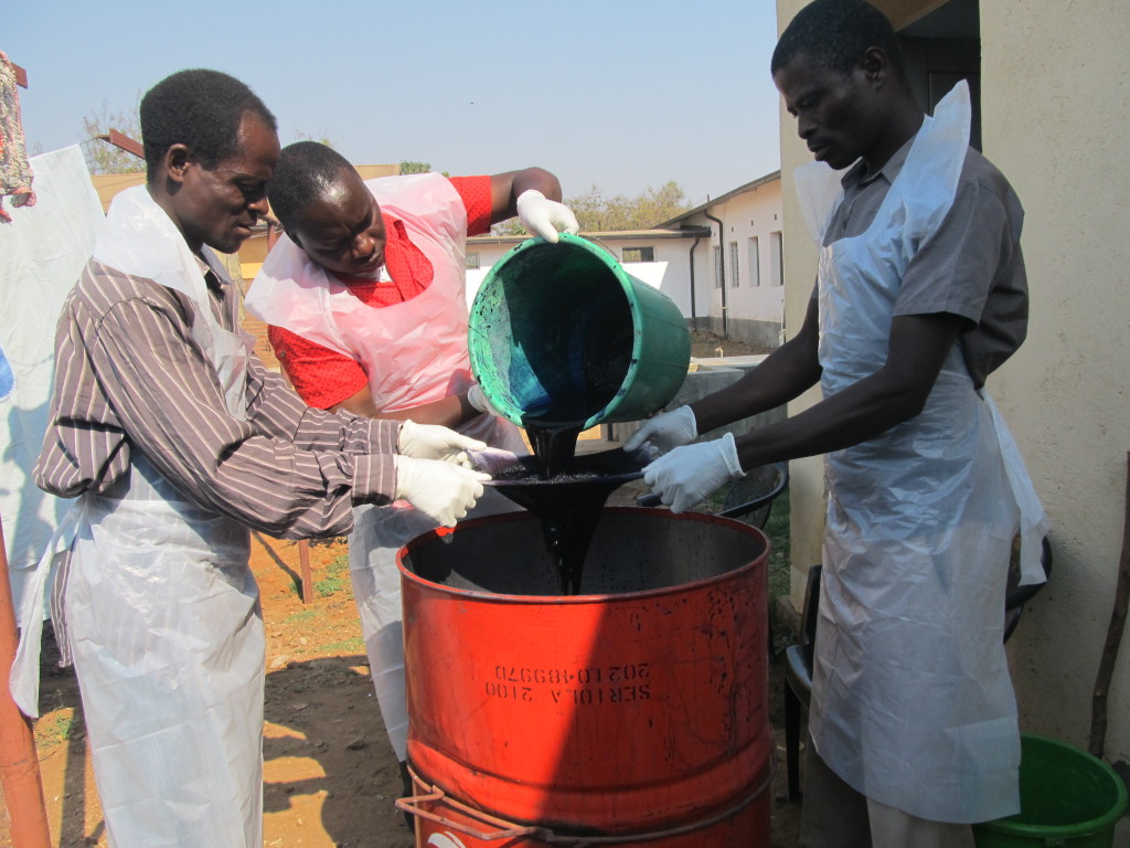 Dyeing process: workers seiving the dye into a mixing drum