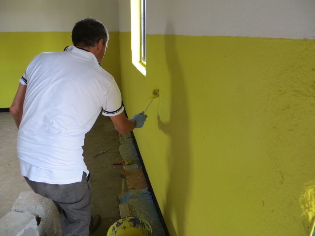 Marco painting the inside of the classroom 